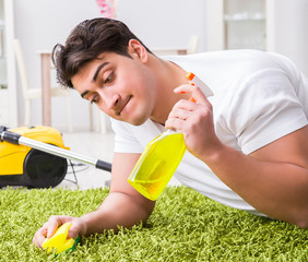 Young husband man cleaning floor at home