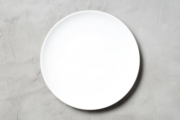 Light textured grey table with empty white plate