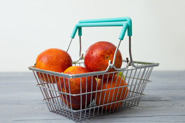 metal basket with red oranges