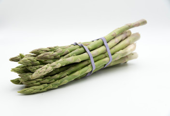 Asparagus surrounded by a medical tape on weighing scale for diets