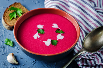 Beet soup with cream and parsley leaves