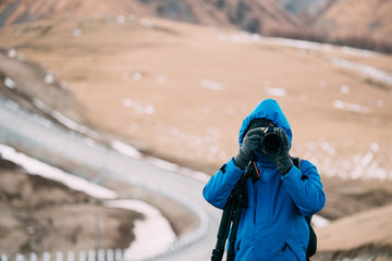 Young Adult Caucasian Man Tourist Backpacker Traveler Photographer Taking Pictures Photos In Beautiful Mountains Landscape In Early Winter