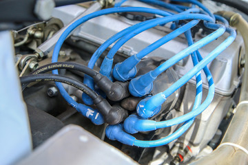 A detail of the sports car engine. It is a historic rallye car from the past. The electrical distributor is visible. 