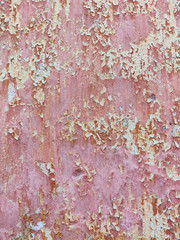 Old wall background, grunge pilled pink paint texture.