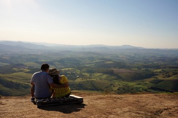 Naklejka na ściany i meble Romantic couple looks at the beautiful view of the Socorro City, Brazil