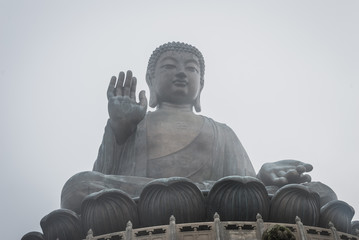 Tian Tan Buddha in misty weather. The second tallest bronze statue of Buddha Shakyamuni in the world, located at Ngong Ping, Lantau Island, Hong Kong