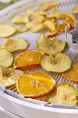 Apple and orange chips cooked in a dehydrator, the theme of healthy eating