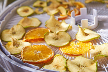 Apple and orange chips cooked in a dehydrator, the theme of healthy eating