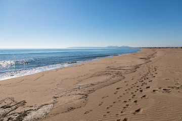 Coast line view with foot prints in the sand