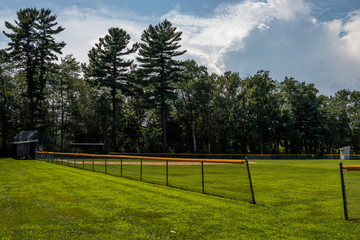 baseball court side view with a beatiful blue sky and white clouds