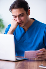 Young male doctor cardiologist working in the clinic