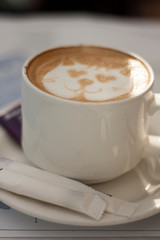 Latte-art on white cup of coffee (cappuccino)