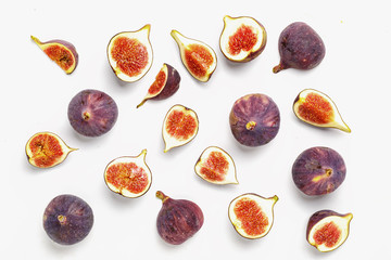 Whole and sliced ripe juicy figs on a white background. Top view.