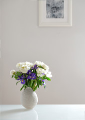bouquet of white peonies and purple irises
