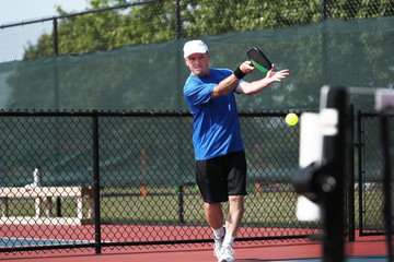 a senior competes in a pickleball tournament