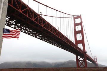 Golden Gate bridge with American flag at half mast