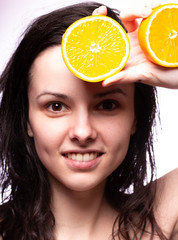 beautiful girl with oranges smiling