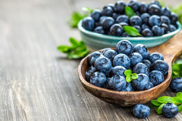 Fresh blueberries background with copy space for your text. Blueberry antioxidant organic superfood in a bowl concept for healthy eating and nutrition - obrazy, fototapety, plakaty