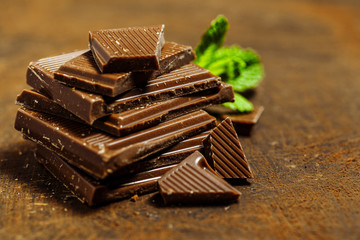 Hazelnut and almond milk and dark chocolate pieces tower.Chocolate bar pieces. Sweet food photo concept. The chunks of broken chocolate