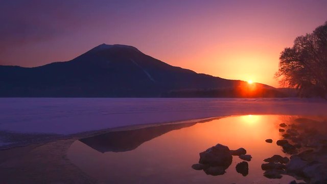 Lake Akan at sunrise with Mount Akan in background