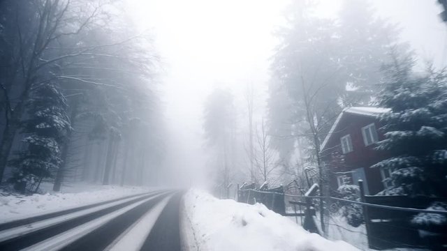 POV personal perspective view from the car - Seebach Germany Baden-Wurttemberg village covered with snow driving fast on snow covered highway - blue color cast