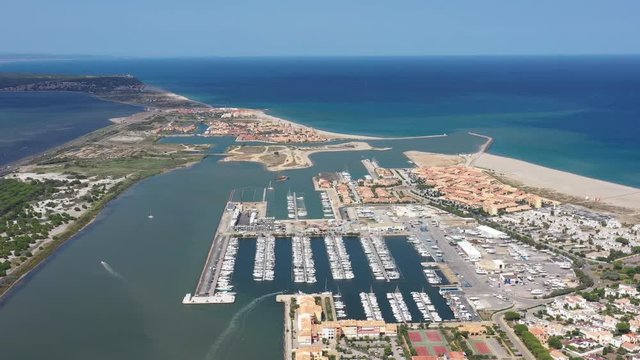 Large aerial shot over Port Leucate mediterranean sea sandy shore sunny day marina harbor