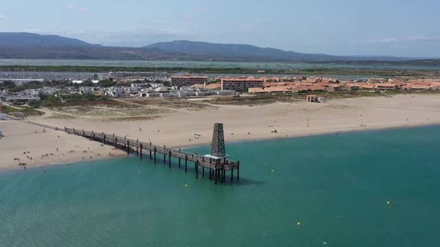Flying around Port Leucate ponton wooden bridge oversea mediterranean shore France Occitanie Aude