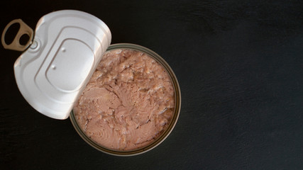 cover is opened tuna fish and black background