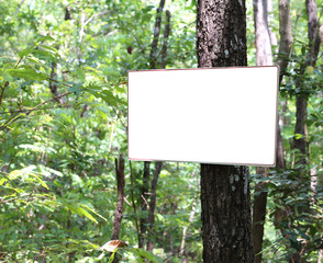 White blank screen sign board on tree at the park.