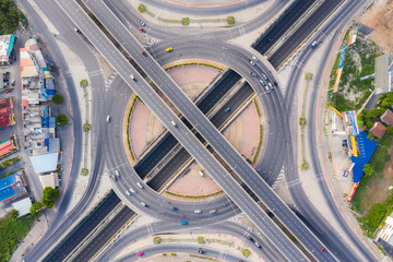 Aerial View Above of Busy Highway Road Junctions at day. The Intersecting Freeway Road Overpass The...