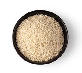white sesame in a bowl isolated on white background. top view