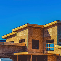 frame Exterior of a house under construction against clear blue sky on a sunny day