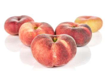 Group of five whole fresh red peach prunus persica platycarpa arranged symmetrically isolated on white background