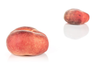 Group of two whole fresh red peach prunus persica platycarpa placed diagonally in line isolated on...