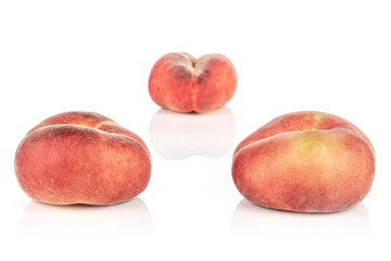 Group of three whole fresh red peach prunus persica platycarpa arranged symmetrically isolated on white background