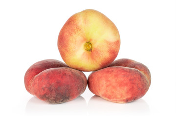 Group of three whole fresh red peach prunus persica platycarpa arranged in pyramid isolated on white background
