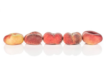 Group of five whole fresh red peach prunus persica platycarpa in row isolated on white background