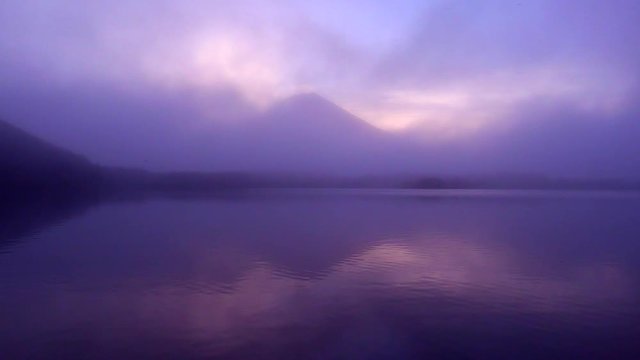 Mountain reflected in lake at sunrise