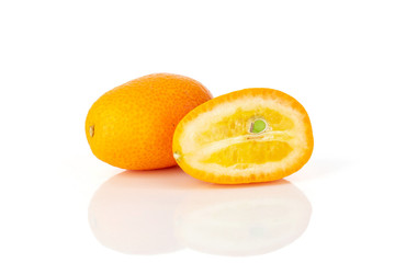 Fototapeta na wymiar Group of one whole one half of fresh orange kumquat isolated on white background