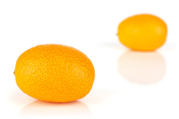 Group of two whole fresh orange kumquat one is in the front isolated on white background