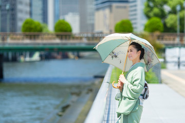 着物（夏結城紬）を着て和柄の日傘を差した日本人女性