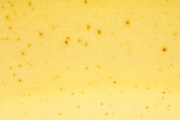 One whole ripe yellow banana skin in closeup isolated on white background