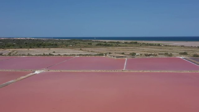 Sand mediterranean sea and pink salt marshes salin de la Palme aerial shot Aude France
