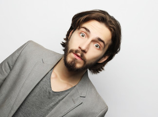 lifestyle, fashion and people concept: Portrait of young man posing over white background