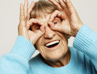 Grey haired old nice beautiful laughing woman. Isolated over white background.