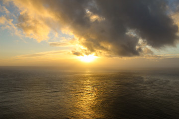 Fototapeta na wymiar Sunset at Cape Reinga, New Zealand where currents collide. 