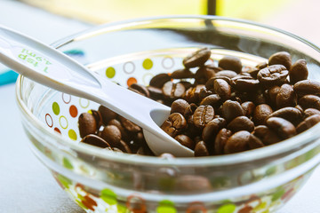 black coffee beans in a bowl