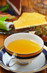Hot fruit-tea with dessert on the table