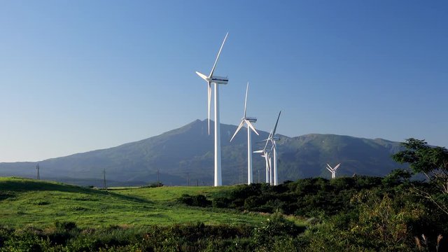 Real time shot of wind turbines against Chokai Mountain, Nikaho, Akita