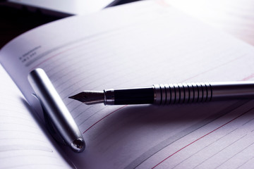 High resolution image, showing a desk working space, with laptop, agenda, pen, phone.